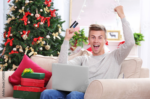 Young man shopping online w...