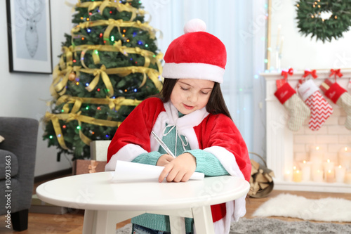 Cute little girl writing le...