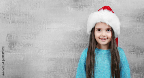 Cute little girl in Santa h...