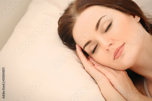 Closeup of young attractive woman sleeping in bedroom