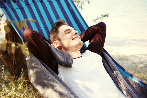 Handsome man relaxing in ha...