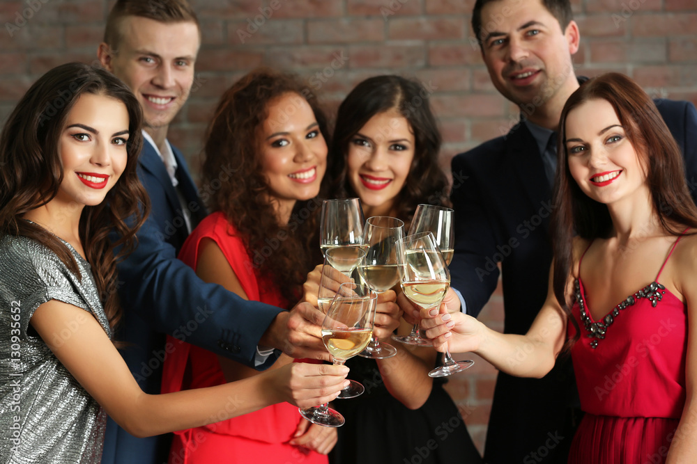 © Africa Studio - People toasting with glasses of white wine