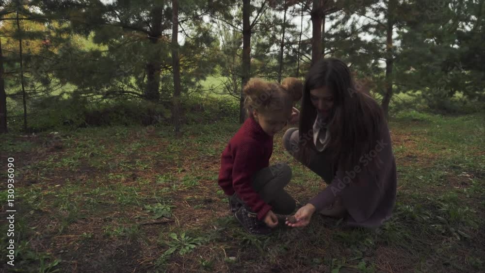 Mother and daughter looking for lumps in the forest 4K Mother and daughter looking for lumps in the forest 4K