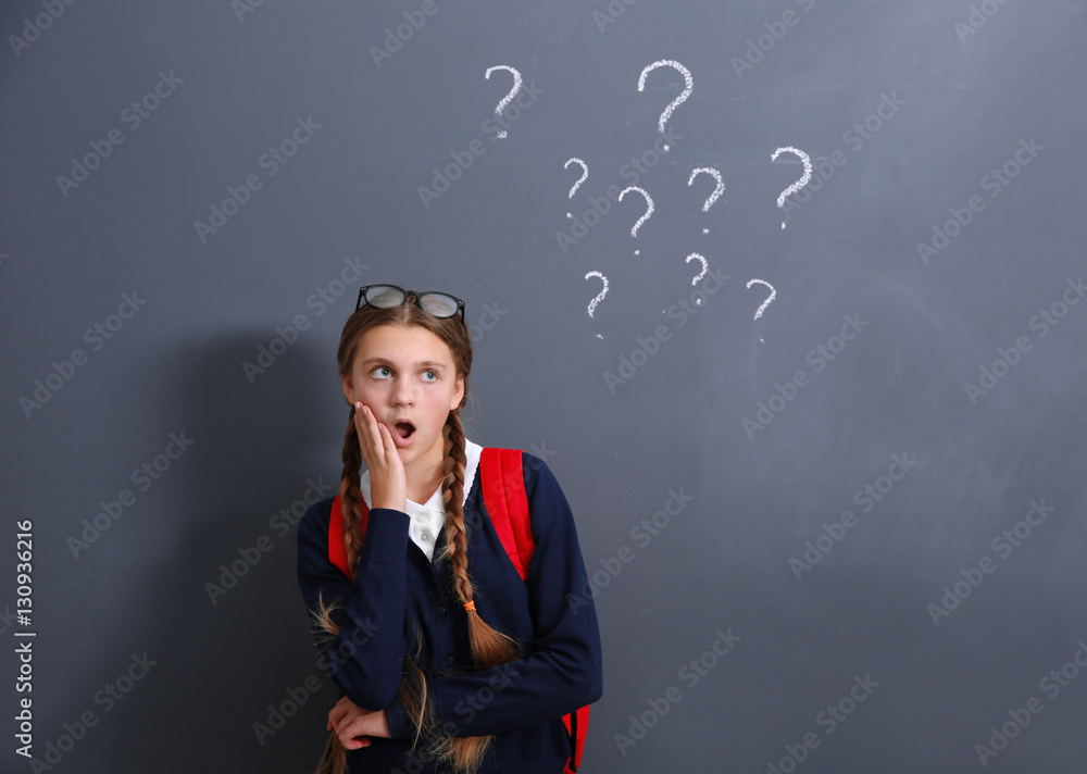 Teenage girl standing near school blackboard Teenage girl standing near school blackboard