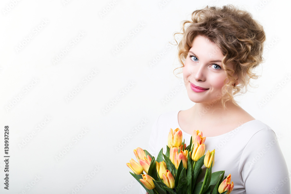 Beautiful smiling girl with flowers.