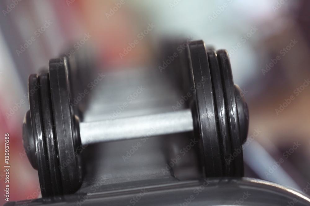 Fototapeta premium Rack with different dumbbells in gym, close up