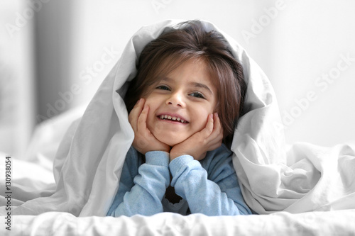 Cute little girl lying on b...