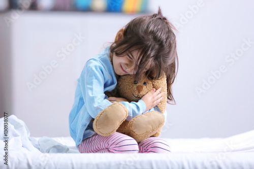 Funny little girl sitting o...