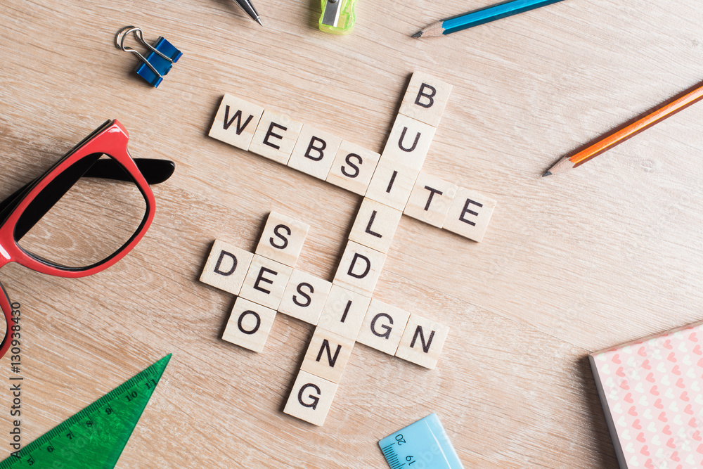 Conceptual media keywords on table with elements of game making crossword Conceptual media keywords on table with elements of game making crossword