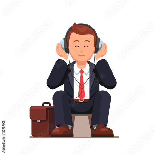 Business man listening to music and sitting