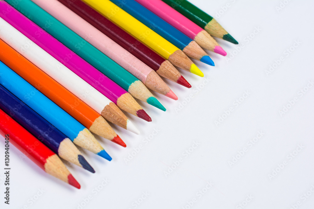 Line of Colored Pencil Crayons Isolated on White Angled View Line of Colored Pencil Crayons Isolated on White Angled View