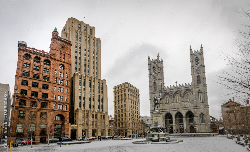 Basilica of Notre-Dame of Montreal and Place d'Armes on snow - Montreal, Quebec, Canada