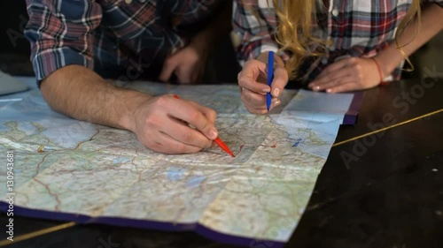 Young tourist couple looking at world map will travel