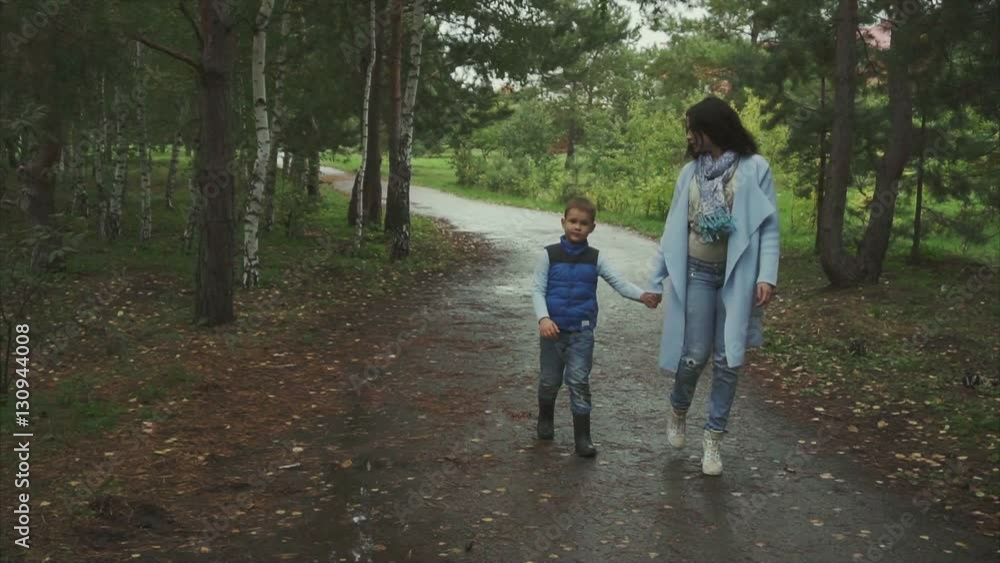 Mother and son walking in the autumn park HD Mother and son walking in the autumn park HD