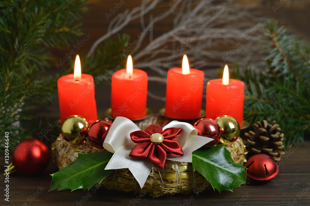 Advent wreath with four burning candles on it. Christmas decoration