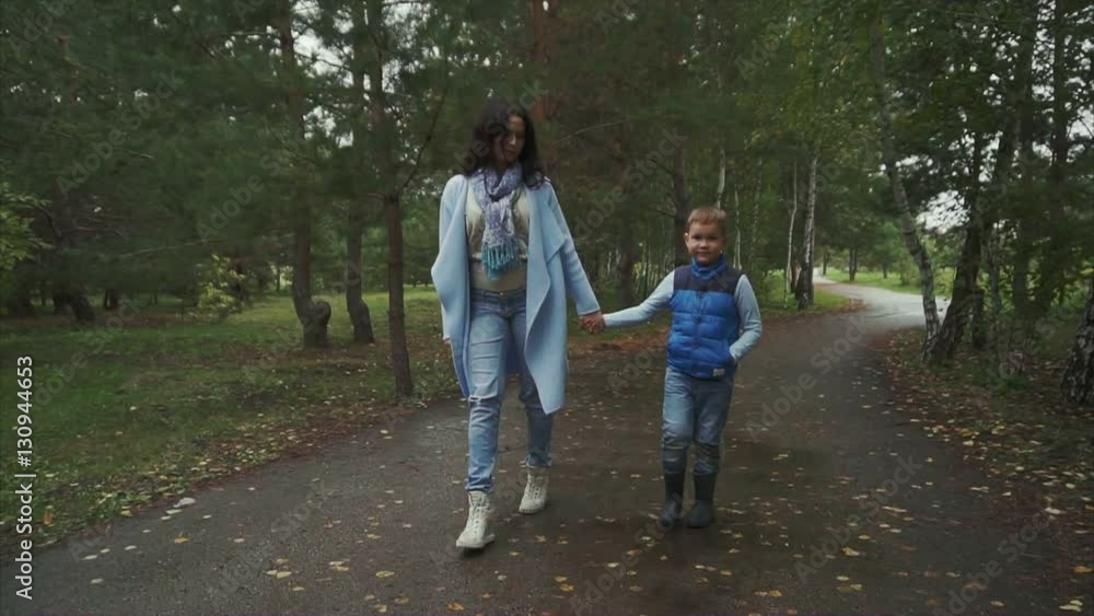 Mother and son walking in the autumn park HD Mother and son walking in the autumn park HD