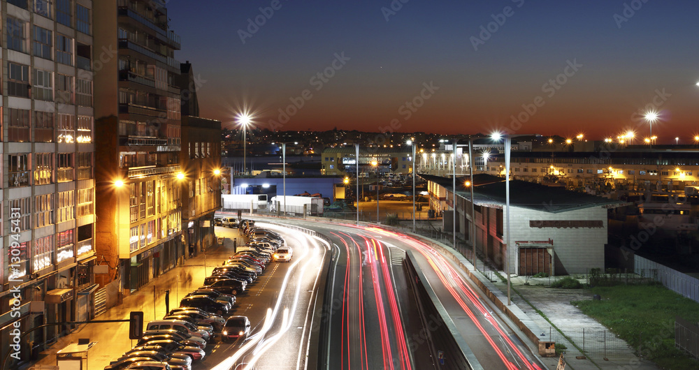 Vigo city at sunset with the lights of cars in motion
