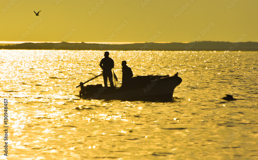 Fishing boat on the sea at sunset.