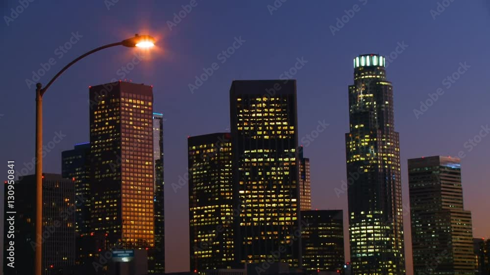 DTLA Skyline Time-lapse. Day to night time lapse view of downtown Los Angeles as the sun sets behind the skyline and the lights in the windows begin to black out. DTLA Skyline Time-lapse. Day to night time lapse view of downtown Los Angeles as the sun sets behind the skyline and the lights in the windows begin to black out.