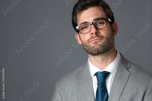 Confident boss business man with smug expression arrogant smirk in suit and tie photo
