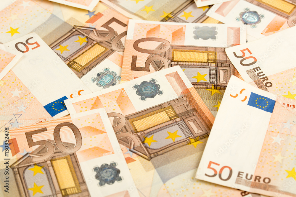 Pile of 50 euro notes - business background. 50 Euro banknotes. Fifty euro money seamless background. Closeup. Pile of 50 euro notes - business background. 50 Euro banknotes. Fifty euro money seamless background. Closeup.