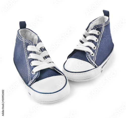 Pair of baby sneakers on white background
