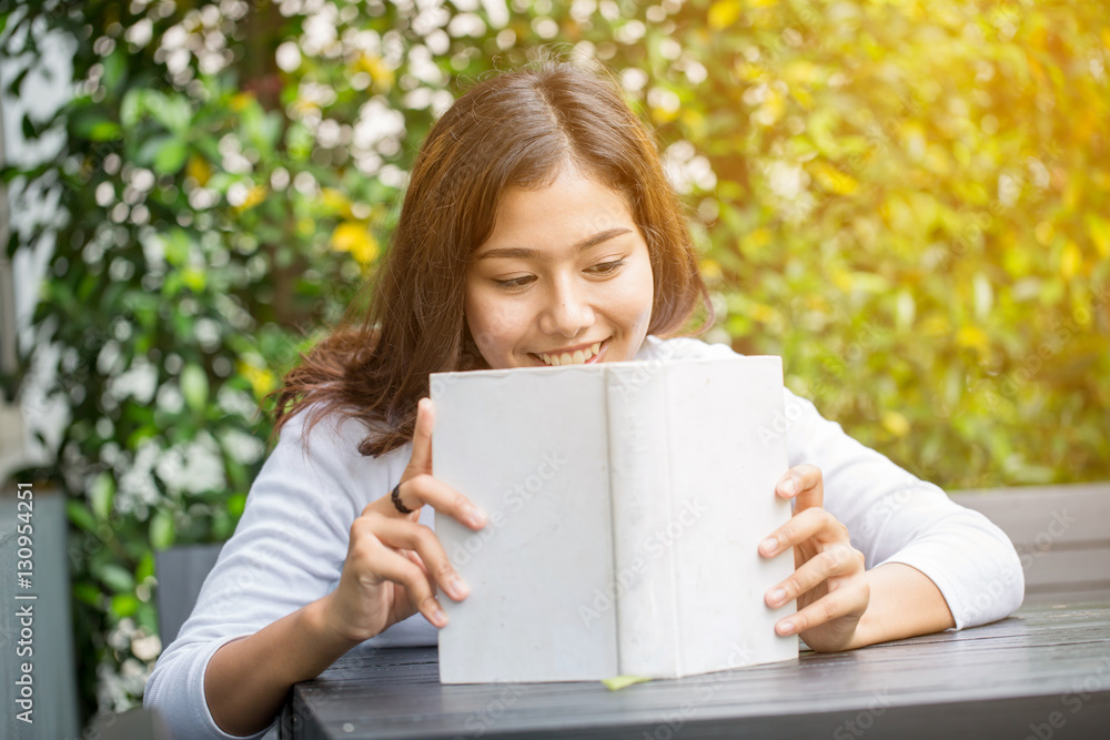 Asian women reading book in the garden Asian women reading book in the garden