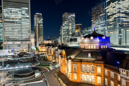 Business concept for real estate and corporate construction - panoramic modern city skyline bird eye aerial night view with tokyo station under dramatic glow and beautiful dark blue sky in Tokyo,Japan © voyata