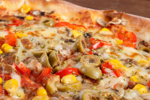 Vegetarian pizza on rustic wooden background, fast food