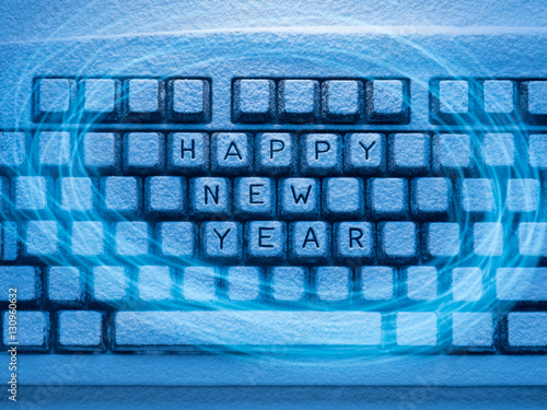 keyboard with inscription Happy New Year illuminated by blue light