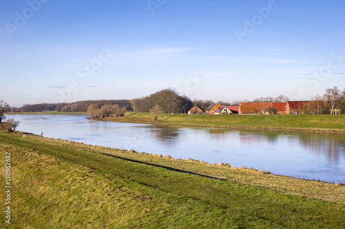 View of a small village directly behind the dyke of the river El