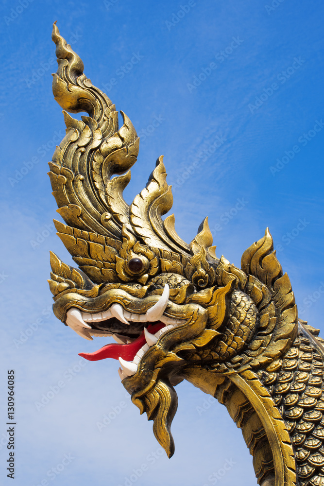 Naga statue head with blue sky background. Naga statue head with blue sky background.