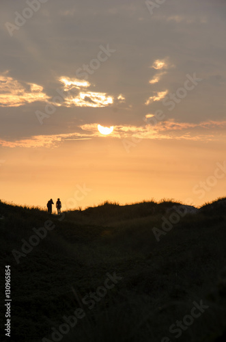 Two people enjoying the sunset at the North Sea © bettysphotos