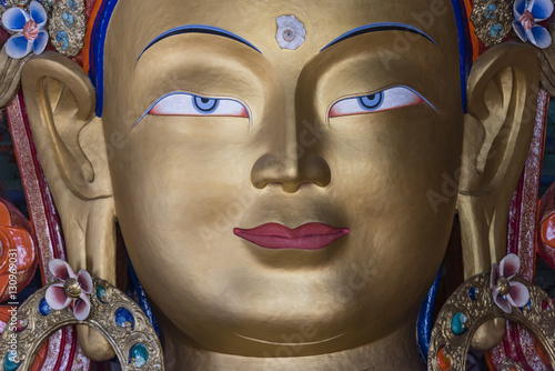 close up of maitreya buddha statue in thiksey monastery photo