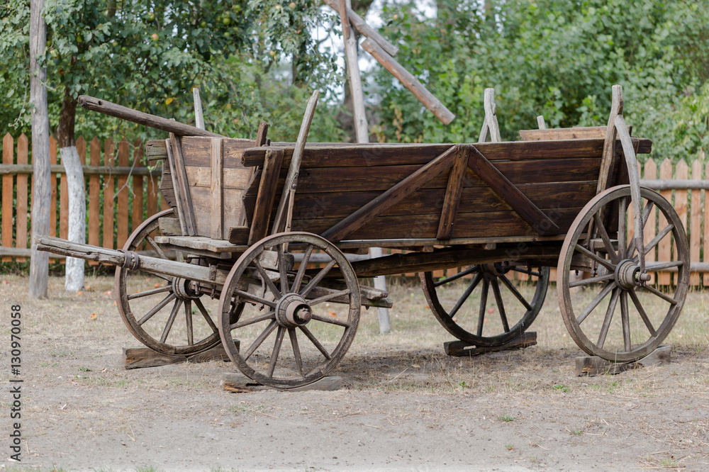 Vintage rustic wooden horse-drawn carriage in Polish farm