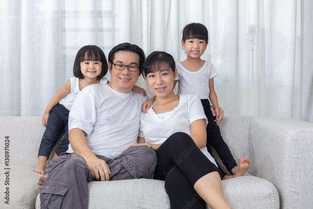 Happy Asian Chinese family sitting on the couch at home Happy Asian Chinese family sitting on the couch at home