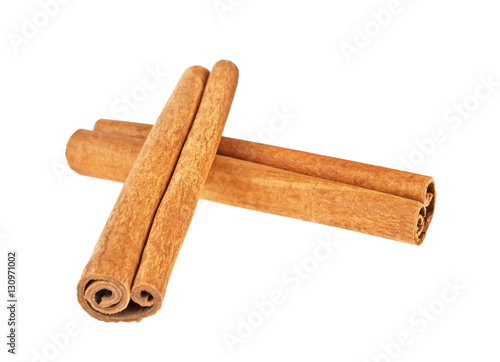 Two cinnamon sticks on white background