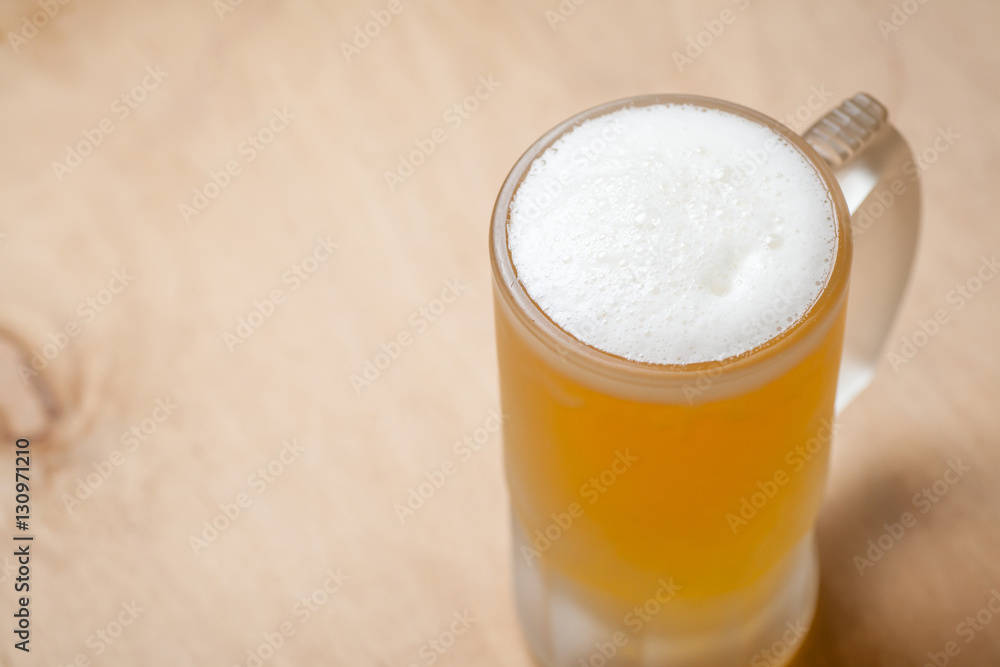 Mug of light beer on wood Mug of light beer on wood
