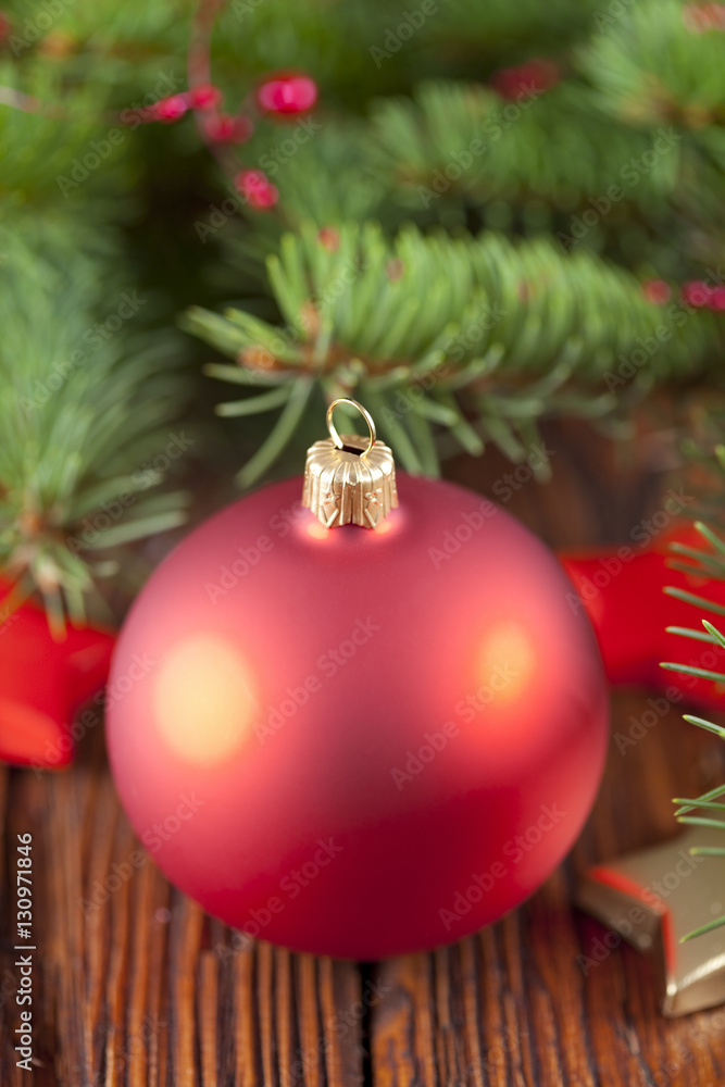Red Christmas bauble on wooden background Red Christmas bauble on wooden background
