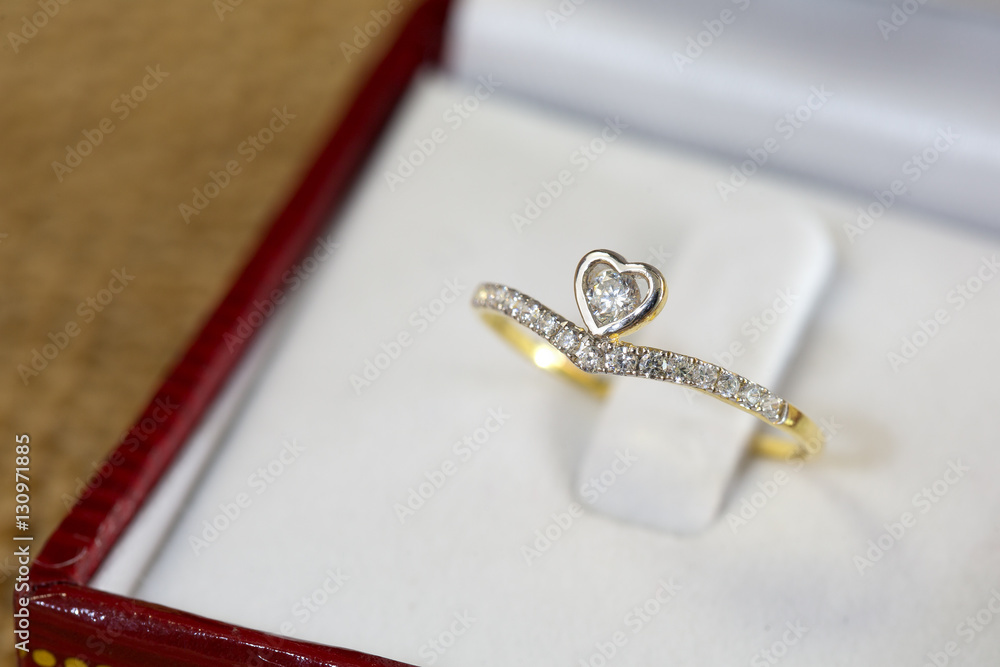Diamond ring, gold body on white base Diamond ring, gold body on white base