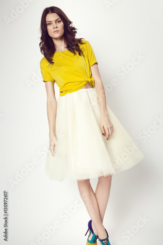 woman in yellow shirt and white skirt