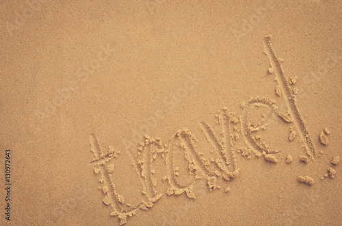 Copy space of travel words hand write on sand beach texture background. © tonktiti