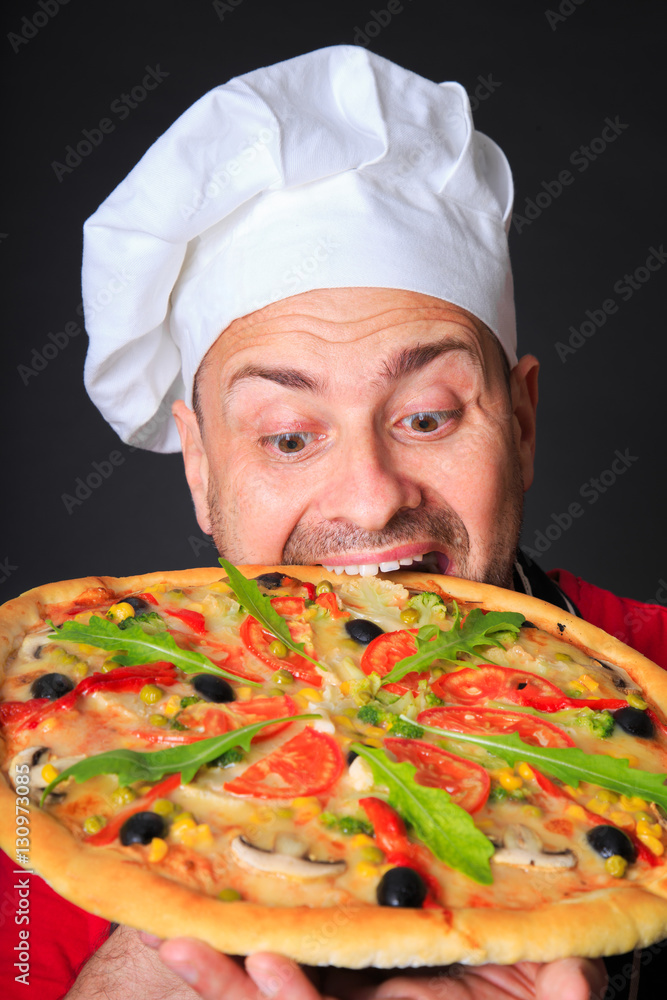 Portrait of happy attractive cook with a pizza Portrait of happy attractive cook with a pizza
