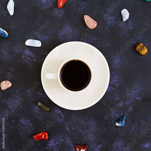 Cup of coffee on dark background. Top view