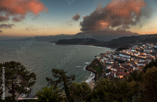 Beautiful view of coastal Asturias sea village Lastres in Spain  Europe during sunset or dusk. Gorgeous panorama of nature traditional famous touristic summer beach destination at dawn.