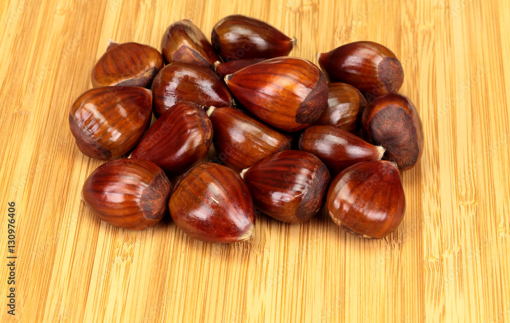 Group of Chestnuts (Castanea), on a wooden board Group of Chestnuts (Castanea), on a wooden board