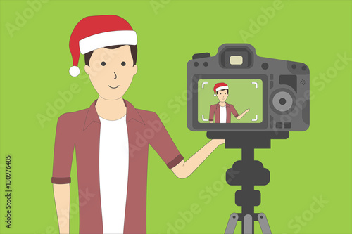 Christmas blog recording on chroma key background. Vlog. Video recording. Handsome boy in santa hat.