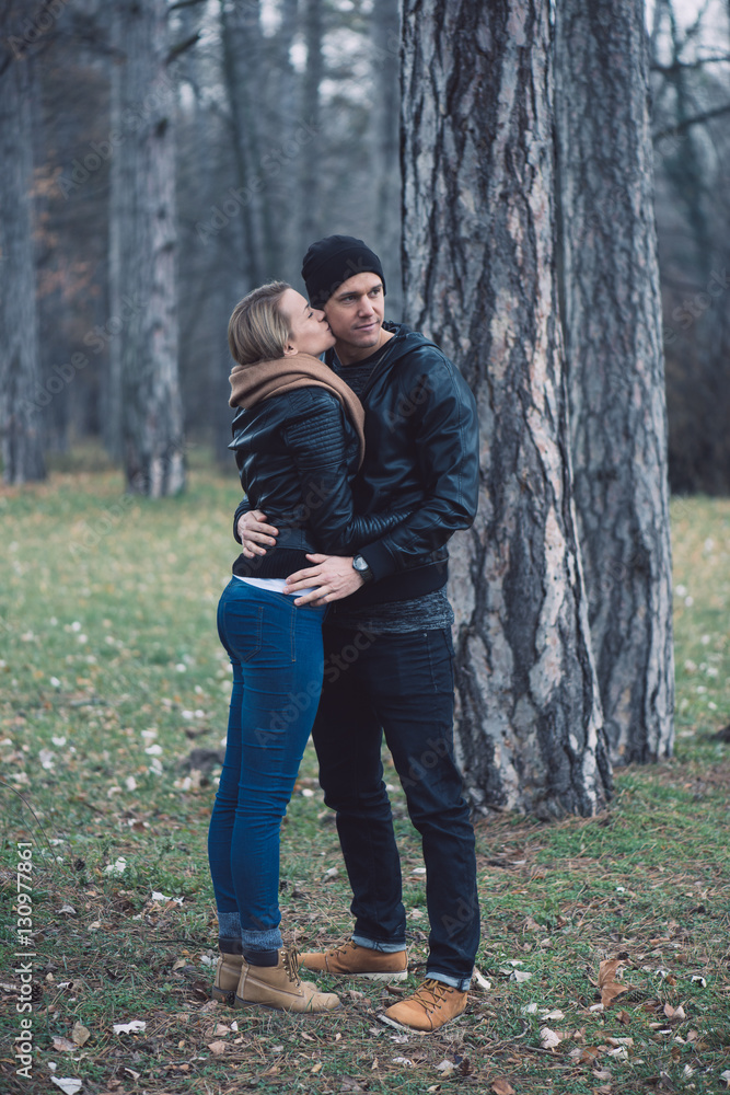 Happy loving couple in park. Outdoor portrait of young couple. Happy loving couple in park. Outdoor portrait of young couple.