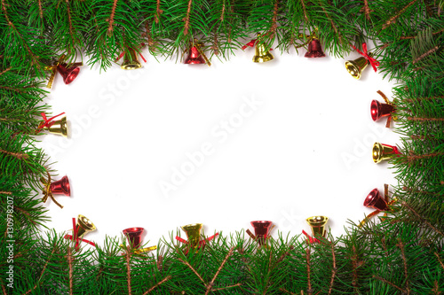 Christmas frame made of fir branches decorated with red bells isolated on white background