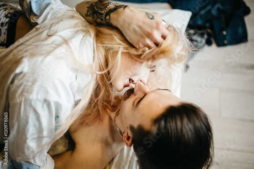 Close up portrait of a young couple kissing.